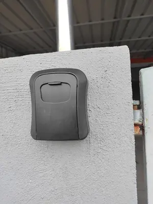 a black object on the side of a white wall at Margosa Homestay in Ipoh