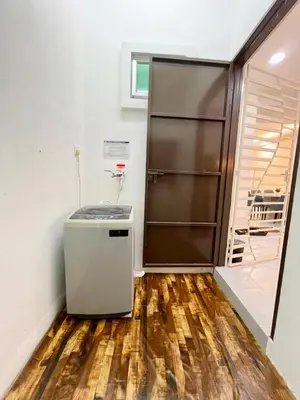 a kitchen with a refrigerator and a wooden floor at Homestay Sungai Petani 3 Bedroom in Taman Mutiara Bandar Puteri Jaya by D'Aleena Homes in Sungai Petani