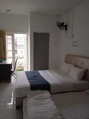 a bedroom with a large bed and a window at Rest N Go CH in Tanah Rata