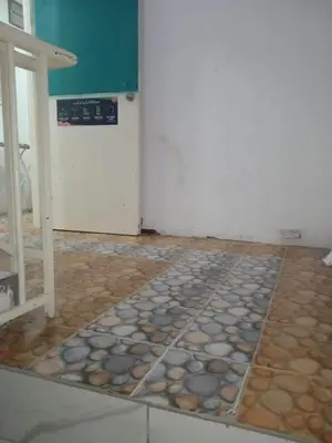 a room with a floor with rocks on the floor at Rest N Go CH in Tanah Rata