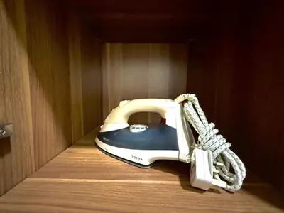 a corded phone sitting on a wooden shelf at Landmark Seaview Cozy Family Suite with Balcony 6 Pax in Tanjong Tokong