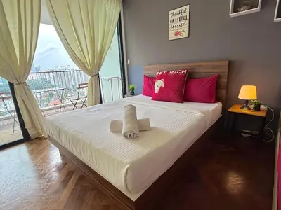 a bedroom with a bed with two stuffed animals on it at Landmark Seaview Cozy Family Suite with Balcony 6 Pax in Tanjong Tokong