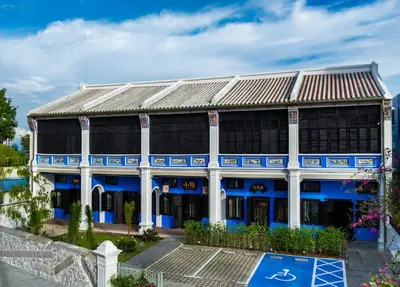 a blue and white building with a metal roof at Cheong Fatt Tze - The Qing Suites in George Town