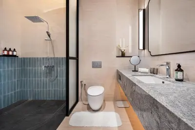 a bathroom with a toilet and a sink and a shower at Cheong Fatt Tze - The Qing Suites in George Town
