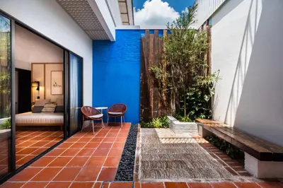 a courtyard with two chairs and a bench at Cheong Fatt Tze - The Qing Suites in George Town