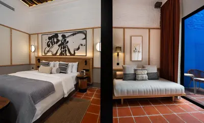 a hotel room with a bed and a chair at Cheong Fatt Tze - The Qing Suites in George Town