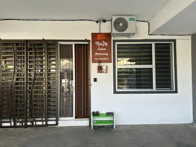 a restaurant with a sign on the side of a building at Nady Salam Homestay in Seri Iskandar