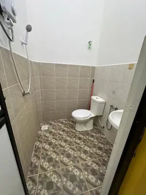 a bathroom with a toilet and a sink at Nady Salam Homestay in Seri Iskandar