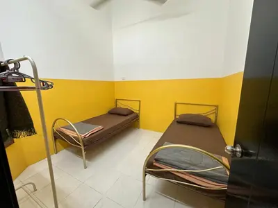 a small room with two bunk beds in it at Nady Salam Homestay in Seri Iskandar