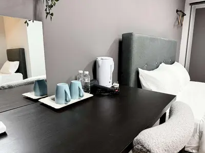 a table with a coffee maker and two mugs on it at Gather inn in George Town