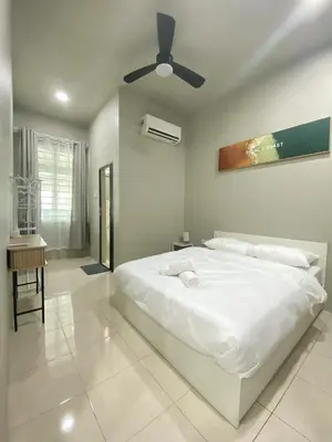a white bedroom with a bed and a ceiling fan at Cozy Corner House, Bandar Utama in Gua Musang