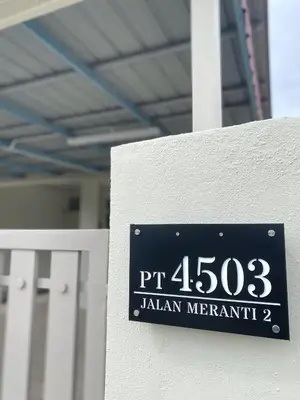 a sign on the side of a building at Cozy Corner House, Bandar Utama in Gua Musang