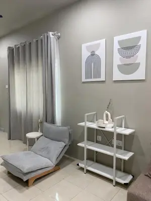 a living room with a chair and a shelf at Cozy Corner House, Bandar Utama in Gua Musang