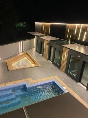 a swimming pool on the roof of a house at night at LYL 108 Private Pool Villa in Ipoh