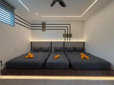 a bedroom with two large blue beds with yellow pillows at LYL 108 Private Pool Villa in Ipoh