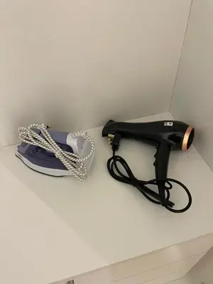 a black corded phone sitting on top of a table at Oasis Condominium Ipoh in Ipoh