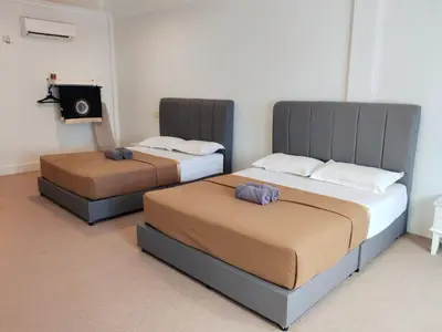 two beds sitting next to each other in a room at Pahang Rest House Raub in Raub