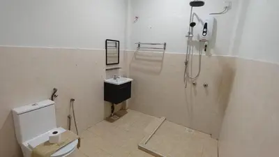 a bathroom with a shower and a toilet and a sink at Pahang Rest House Raub in Raub