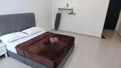 a bedroom with a bed with two slippers on it at Pahang Rest House Raub in Raub