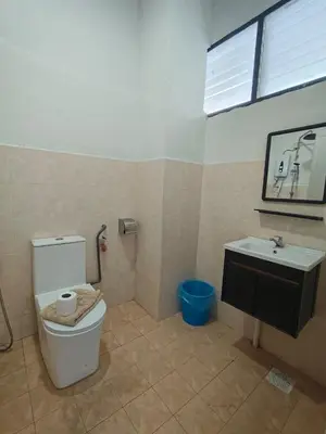 a bathroom with a toilet and a sink at Pahang Rest House Raub in Raub