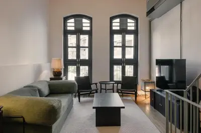 a living room with a couch and a tv at Cheong Fatt Tze - The Townhouses in George Town