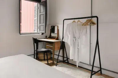 a bedroom with a bed and a desk and a mirror at Cheong Fatt Tze - The Townhouses in George Town