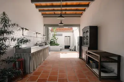 a kitchen with a tile floor and a kitchen with a sink at Cheong Fatt Tze - The Townhouses in George Town