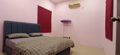 a bedroom with a bed and a red window at Lavender Splash Homestay in Ipoh