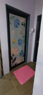 a door with a pink rug and a door with flowers on it at Lavender Splash Homestay in Ipoh