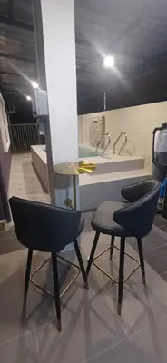 two chairs and a table in a kitchen with a sink at Lavender Splash Homestay in Ipoh