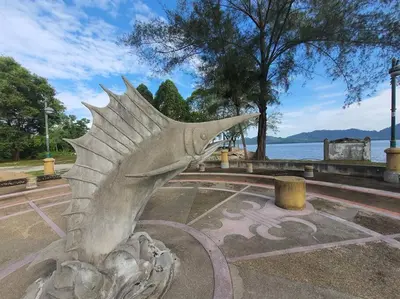 a statue of a fish sitting in a park at Lumut Homestay for Muslims in Lumut