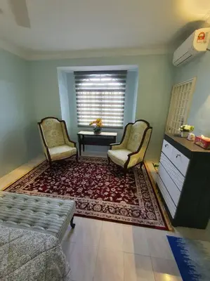 a living room with two chairs and a table at Lumut Homestay for Muslims in Lumut