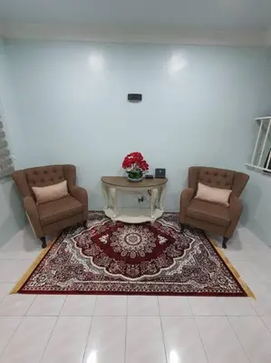 a living room with two chairs and a coffee table at Lumut Homestay for Muslims in Lumut