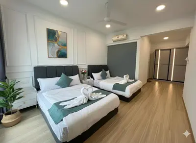 a hotel room with two beds with towels on them at High floor Seaview 2BR Jazz Suite Bathtub &Sauna in Tanjong Tokong