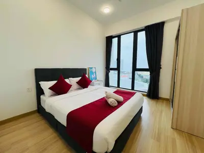 a bedroom with a large bed with a stuffed animal on it at High floor Seaview 2BR Jazz Suite Bathtub &Sauna in Tanjong Tokong