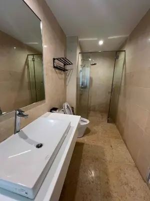 a bathroom with a sink and a toilet and a mirror at High floor Seaview 2BR Jazz Suite Bathtub &Sauna in Tanjong Tokong