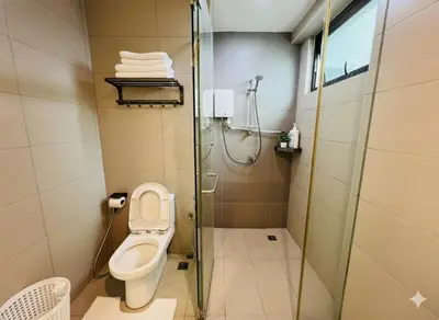 a bathroom with a toilet and a glass shower at High floor Seaview 2BR Jazz Suite Bathtub &Sauna in Tanjong Tokong