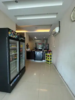 a fast food restaurant hallway with a drink refrigerator at Liner hotel in Simpang