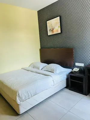 a bedroom with a bed and a picture on the wall at Liner hotel in Simpang