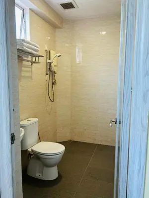 a bathroom with a toilet and a shower at Liner hotel in Simpang