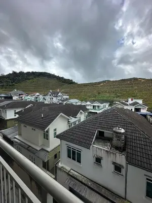 a view of a city with white houses and hills at Barrington Square Aleysha Homestay Night Market in Brinchang