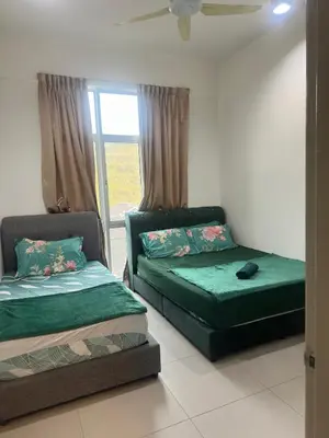 two beds sitting in a room with a window at Barrington Square Aleysha Homestay Night Market in Brinchang