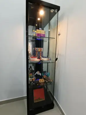 a glass cabinet with a bunch of items in it at Lahat Serenity 168 Big Corner Cozy House in Lahat