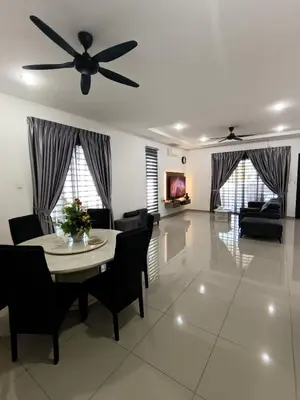a living room with a table and a ceiling fan at Lahat Serenity 168 Big Corner Cozy House in Lahat