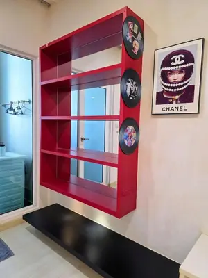 a red book shelf with a mirror in a room at Pico City Suite #1BR in George Town