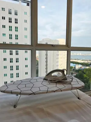 a bed in the middle of a room with windows at Pico City Suite #1BR in George Town