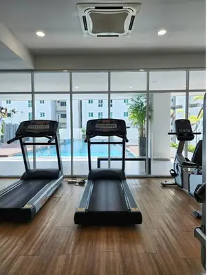 a gym with two treadmills in the middle of a room at Pico City Suite #1BR in George Town