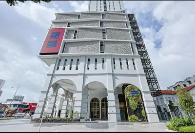 a tall white building with a lot of windows at 22Macalisterz Georgetown Studio in George Town