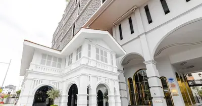 a large white building with windows on a street at 22Macalisterz Georgetown Studio in George Town