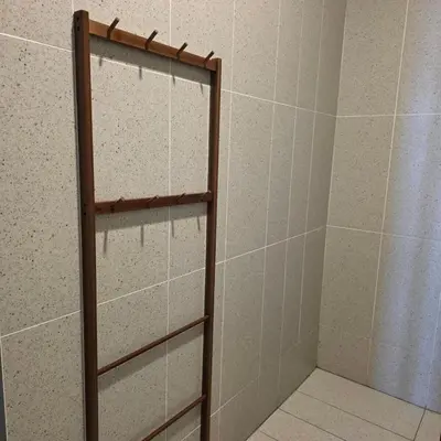 a shower with a wooden rack in a bathroom at 22Macalisterz Georgetown Studio in George Town
